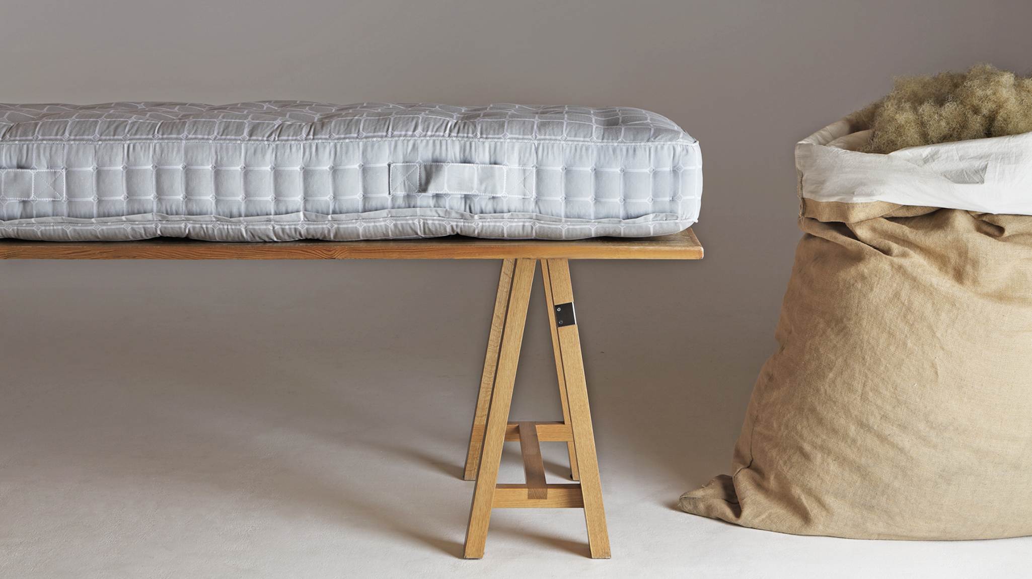 Image of a Savoir mattress on a crafts table with a bag of lavish horsetail next to it