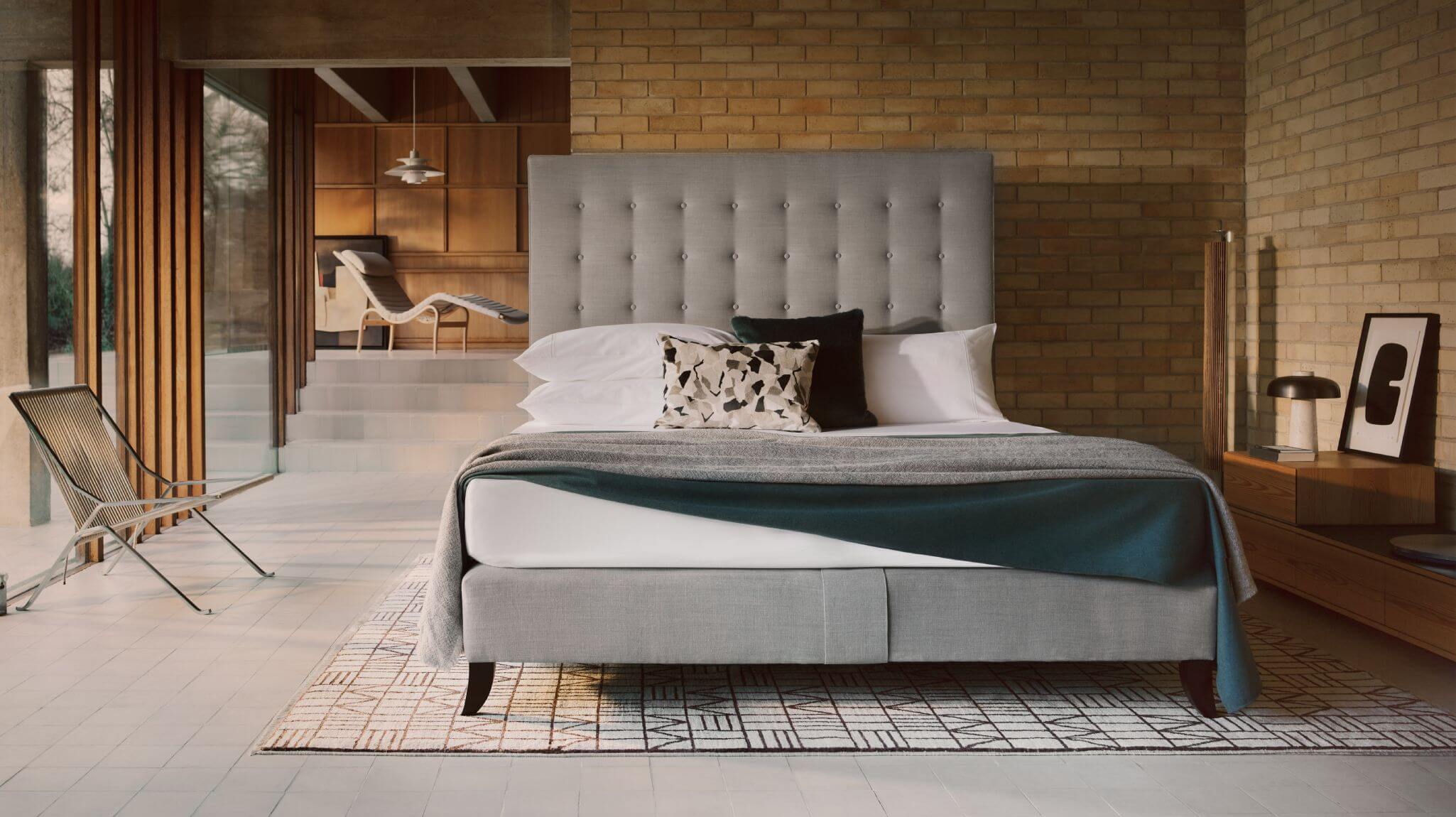 Image of the Holly design against a pale-yellow brick wall of the lounge at Ahm House
