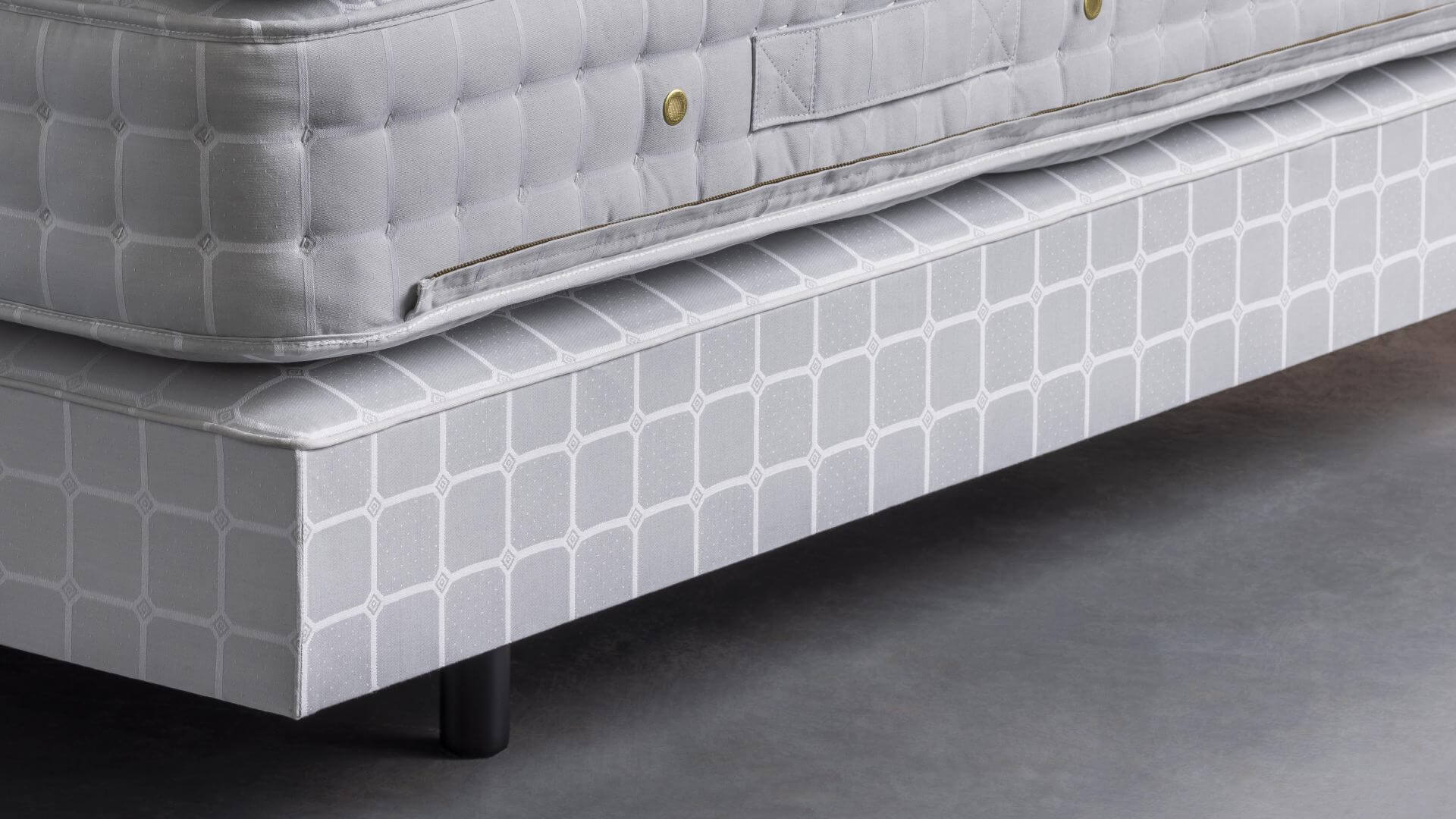 Base of our No5 bed, featuring the plump No5 mattress, all upholstered in Savoir's signature blue cotton with Trellis ticking pattern.