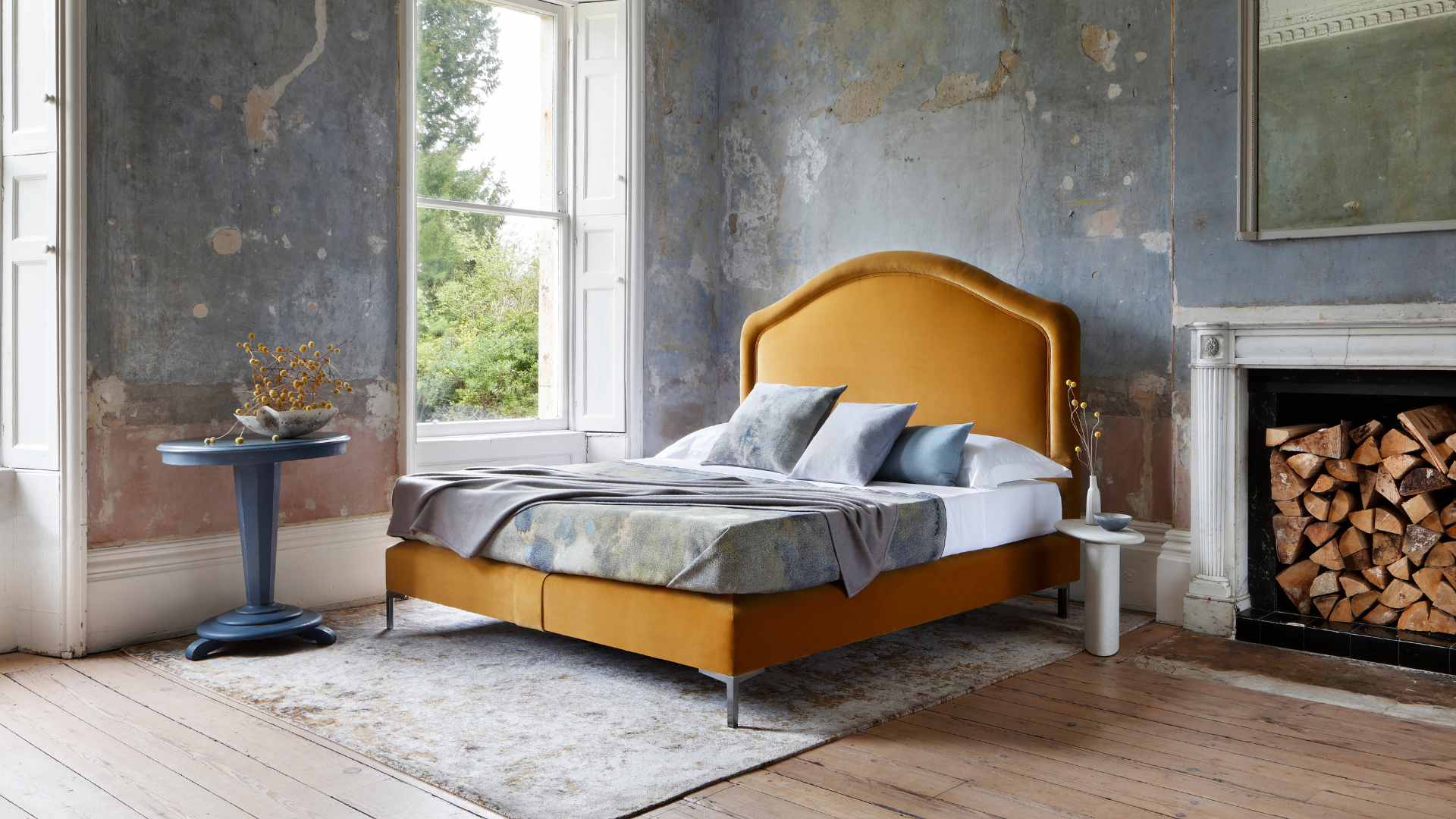 Our Cassie bed, featuring a mustard headboard and soft edges and charming curves in a