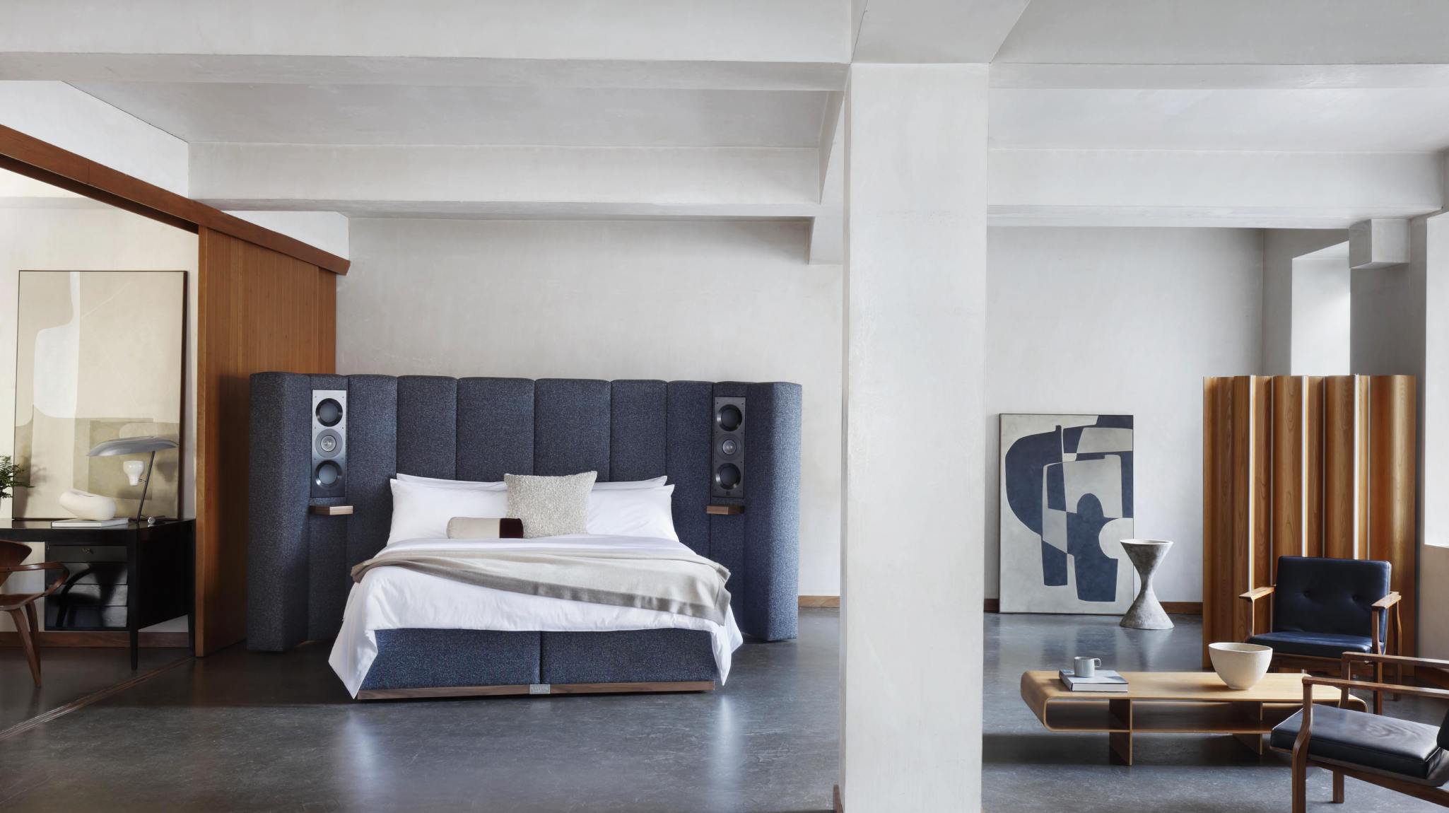 Savoir's luxury speaker bed upholstered in textural blue wool with integrated architectural speakers by British brand KEF