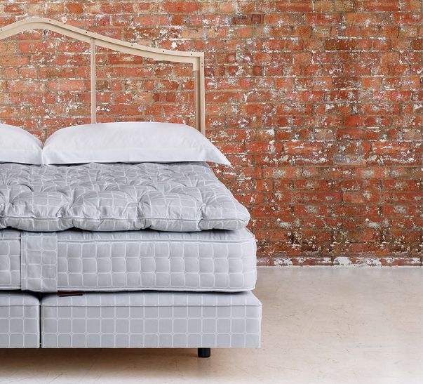 Savoir bed featuring the no3 base, the mattress, the topper and cushions with our naked headboard
