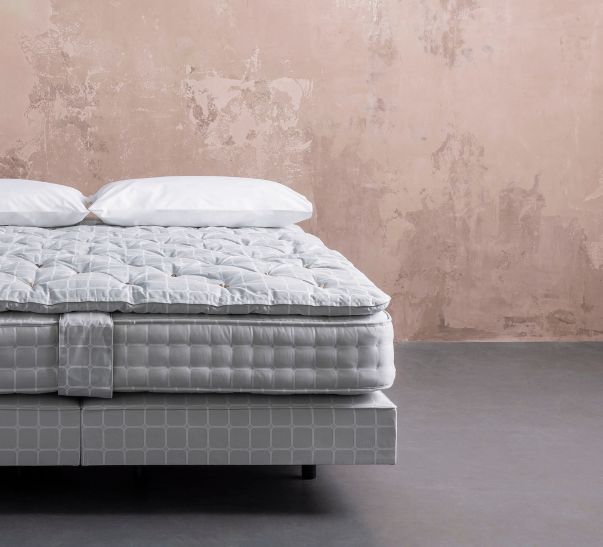 Savoir bed featuring the no4 base, the mattress, the topper and cushions with our naked headboard