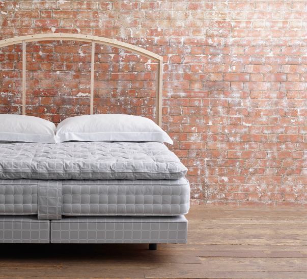 Savoir bed featuring the no4 base, the mattress, the topper and cushions with our naked headboard