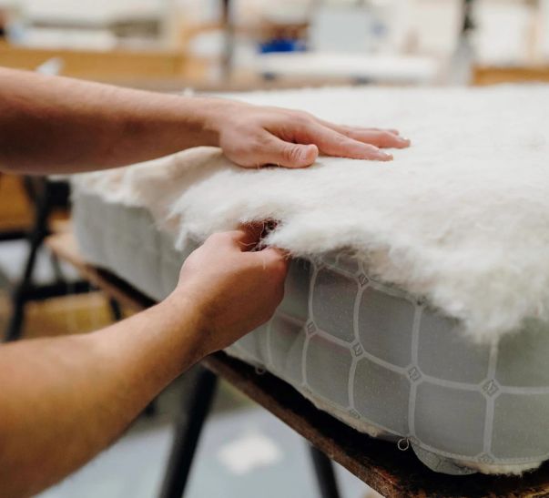 Craftsman putting sumptuous layers of soft, moisture wicking and temperature-regulating wool for a No5 mattress